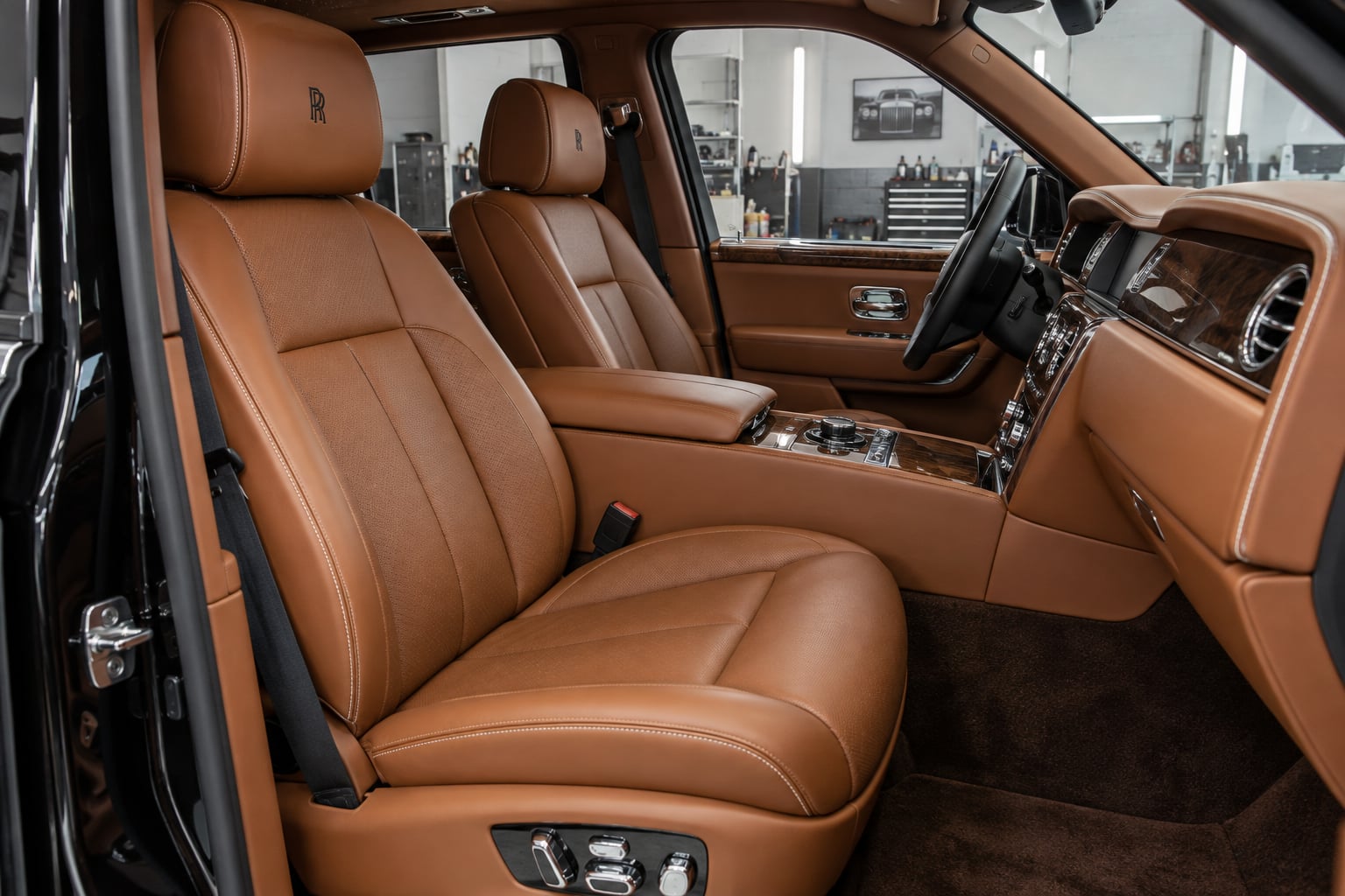 AI concept of a Rolls-Royce Cullinan cognac leather interior in an enclosed upholstery workshop